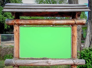 a large billboard for advertising based on logs in the background of the garden
