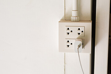Electrical plugs that are plugged in except copy space