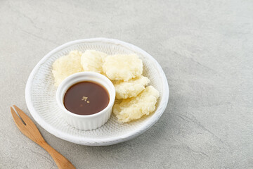 Cireng, a savory snack from West Java, Indonesia, made from tapioca flour and deep-fried, served with a spicy sauce.
