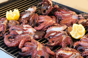 octopus with tentacles cooked on the metal grill in the seafood restaurant in the Mediterranean...