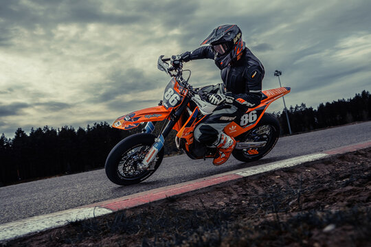 10-05-2020 Ropazi, Latvia Motorcyclist at supermoto rides by empty asphalt road