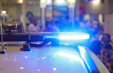 flashing blue of the police car during the protest
