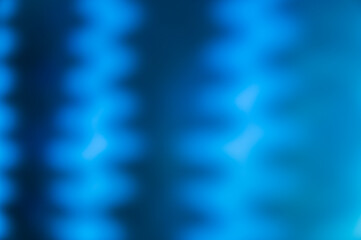 A defocused shot of black silhouettes on a blue wall. Creative background with alternating...