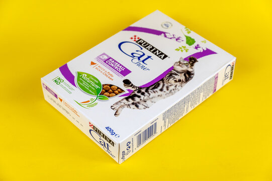 Purina Cat Chow cat food. Cardboard box with dry pelleted food for pets. Yellow background. Selective focus. Ukraine, Mykolayiv - 05 25 2022