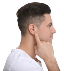 Obraz premium Man pointing at his ear on white background
