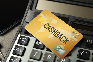 Cashback credit card and calculator, closeup view