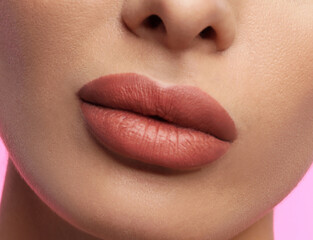Woman with beautiful perfect lips after permanent makeup procedure on pink background, closeup - obrazy, fototapety, plakaty