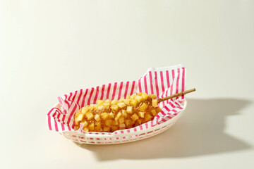 Delicious Crunchy Korean Style Chunky Potato Corn Dogs with Batter and Fried Potatoes. - obrazy, fototapety, plakaty