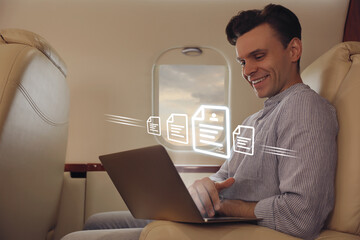 Concept of electronic signature. Man using laptop in airplane during flight