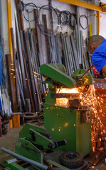 working man working with a disc cutter in a family business.