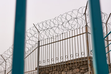 The barbed wire from - behind the bars. The concept is a dictatorship, a violation of human rights.
