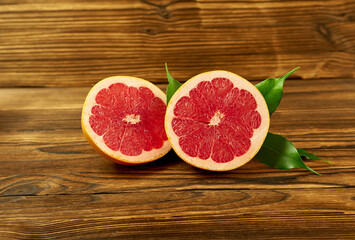 Grapefruit halves on a wooden background.