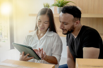 Caucasian man and Asian woman couple using laptop 