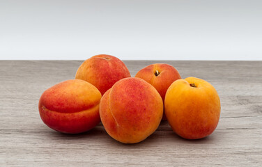 Naklejka na ściany i meble Fresh apricots isolated on wooden table.