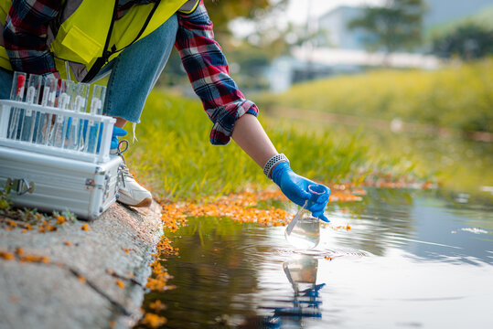 Hands of scientists collecting water samples for analysis and research on water quality.