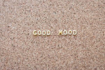 Good mood text on cork background. Mood board background. Positive phrase. Letters on cork wallpaper. Positive slogan. Creative message. Lifestyle concept. Letters on board.