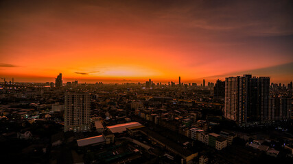 The high angle background of the city view with the secret light of the evening, blurring of night lights, showing the distribution of condominiums, dense homes in the capital community