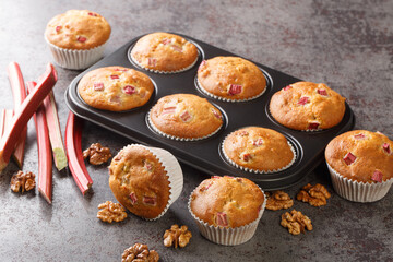 Rhubarb Walnut Muffins close-up in a baking dish on the table. horizontal
