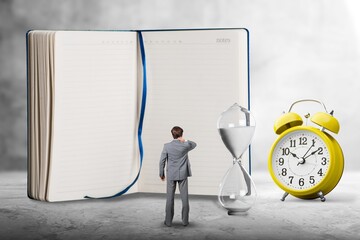 Alarm clock and notebook, concept of  Fixed-Term Contract on a background