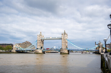 View of the famous London Tower Bridge from the Thames river. Cloudy day