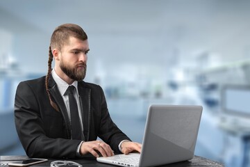 Young Businessman Using Laptop Computer Sitting During Break
