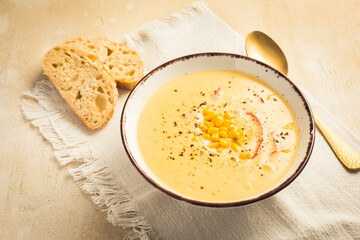 Delicious creamy chilli cheese corn soup served with bread
