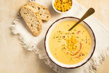 Delicious creamy chilli cheese corn soup served with bread