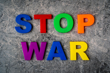 The inscription Stop War in plastic letters on a stone background