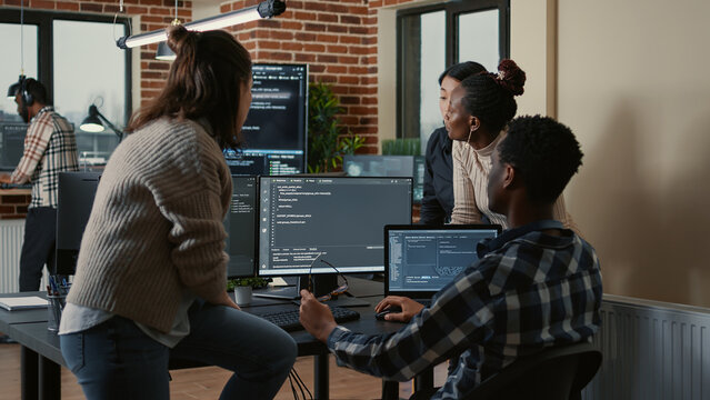 Software Developers Discussing About Cloud Programming Innovation While The Rest Of The Team Joins The Discussion. Programmers Doing Teamwork Computing Big Data In Server Room.