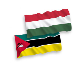 National vector fabric wave flags of Republic of Mozambique and Hungary isolated on white background. 1 to 2 proportion.