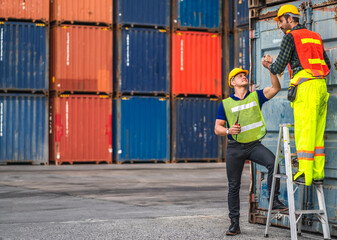 Fototapeta na wymiar Professional engineer container cargo foreman team in helmets working standing and using walkie talkie checking stock into container for loading.logistic transport and business industry export