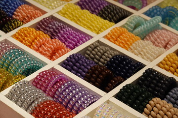 Group of colorful spiral rubber bands in wood box