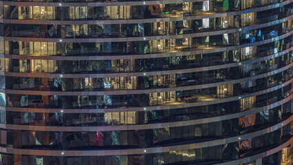 Outside view of windows in apartments of a high class building at night timelapse