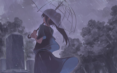 お墓の前に傘をさす女の人