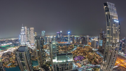Aerial panorama of a big futuristic city night timelapse. Business bay and Downtown