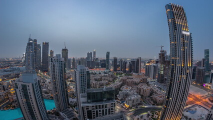 Aerial panorama of a big futuristic city night to day timelapse. Business bay and Downtown