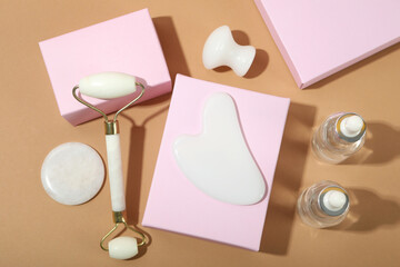 Face care concept with gua sha, face roller and cosmetic