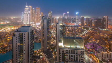 Obraz premium Aerial view of a big futuristic city day to night timelapse. Business bay and Downtown