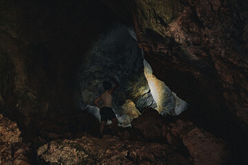 explorer finds a cave in the jungle