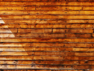 Rustic brown wooden plank wall as background. Texture of painted wood boards.
