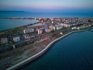 Naklejka na ściany i meble View from a height above the town of Pomorie with houses and streets washed by the Black Sea in Bulgaria