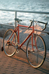 road bicycle leaning on a metal handrail. concept of a lifestyle living near the sea.