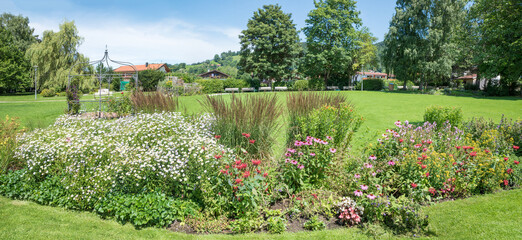 Fototapeta premium flower bed with echinacea, monarda and asters at spa garden Schliersee