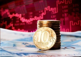 Ruble coin on the background of the falling graphics, the concept of inflation, the crisis in...