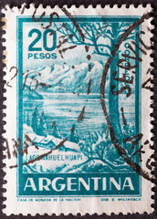 ARGENTINA - CIRCA 1960: a postage stamp from ARGENTINA, showing a landscape with mountains at Nahuel Huapi Lake. Circa 1960