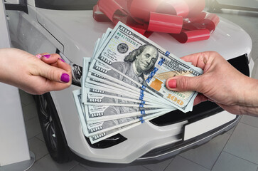 buying an SUV in good car dealership from a friend at a discount. Men exchange keys and money.