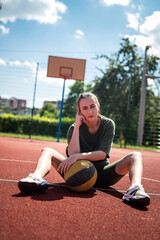 Fototapeta premium charm young woman with basketball on sports playground