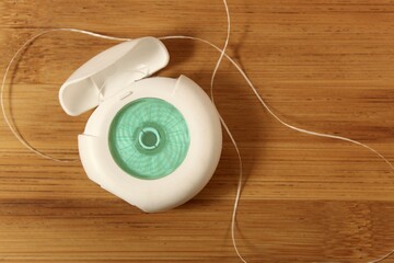 dental floss on a wooden table. An opened dental floss for teeth cleaning concept.