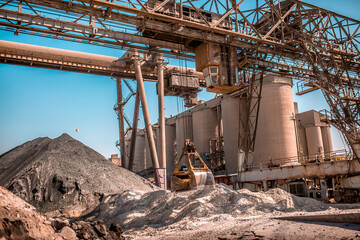 Cement factory. Pipes and compressors, equipment, metalurgy. Modern technologies work at a cement plant. Technological work on the production of cement. Working atmosphere with copy space.