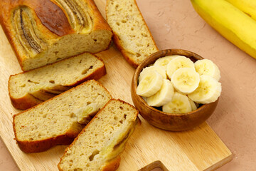 Baked banana bread, sliced on a cutting board. Bakery, cafe, home chef, menu concept